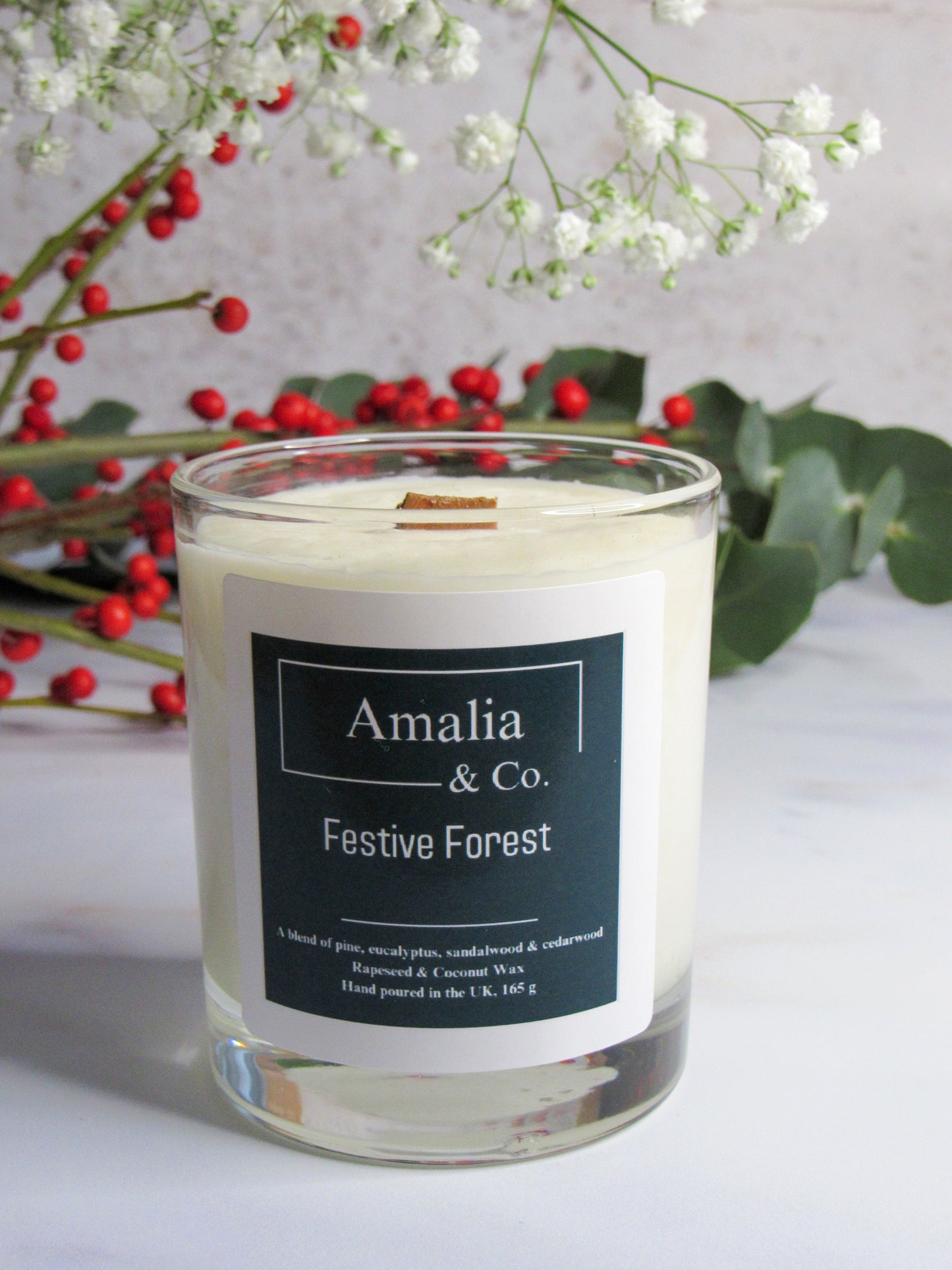 Festive Forest scented candle with notes of pine and cedarwood, perfect for holiday-inspired ambience with woody and warm fragrances