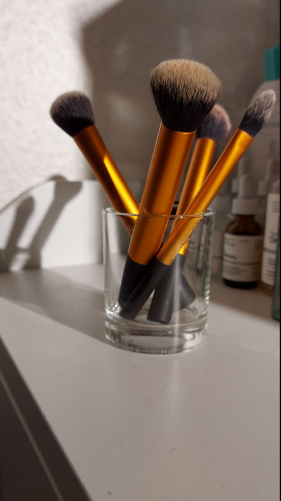 Eco-friendly makeup brush holder using a reused candle jar from Amalia & Co. - sustainable beauty storage idea