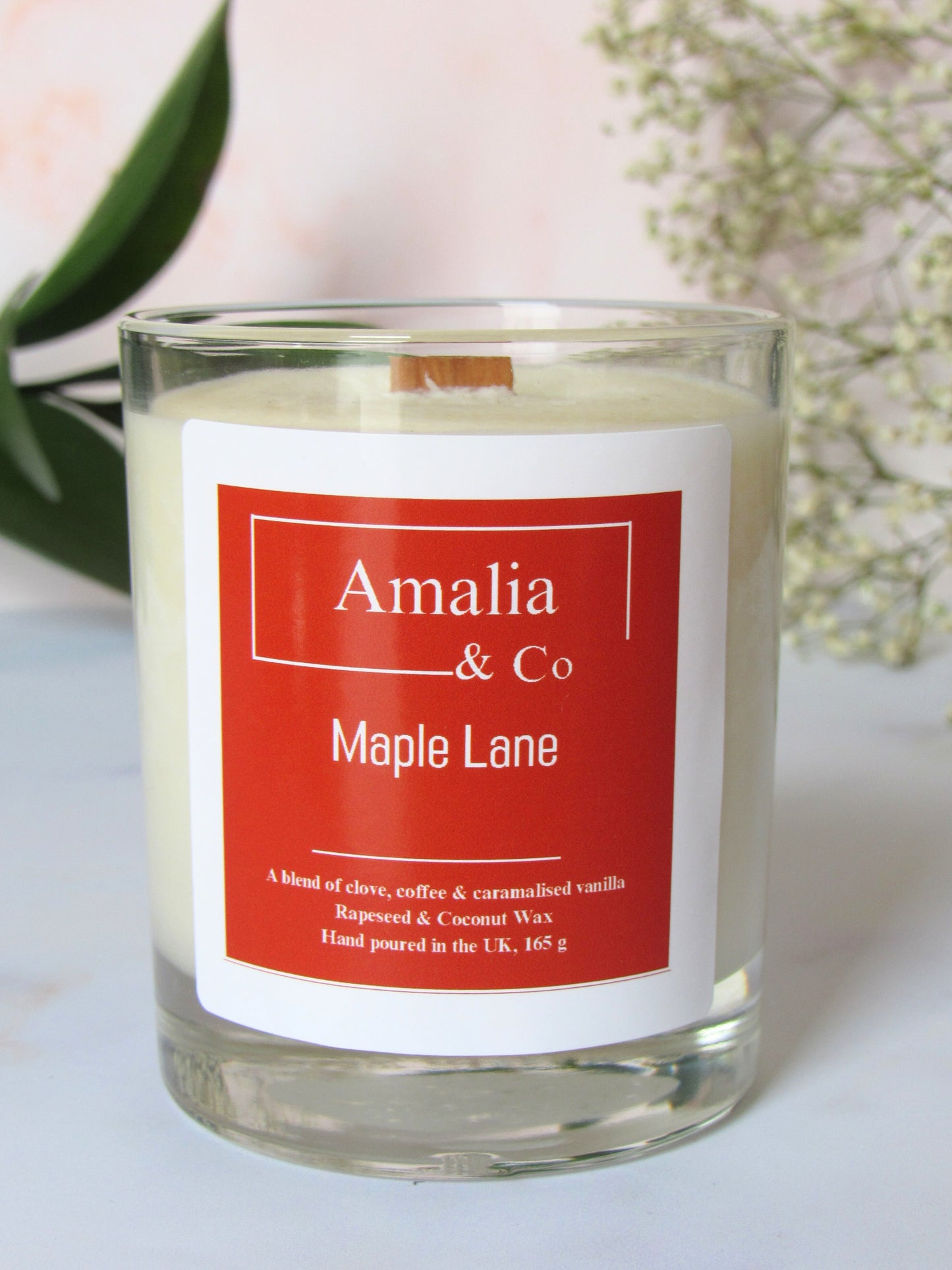 Maple Lane luxury candle with a blend of cocoa, clove, ginger, nutty coffee, and caramelized vanilla, providing a warm, cozy atmosphere